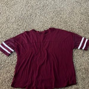 Maroon shirt sleeve tee shirt with white stripes on the sleeves